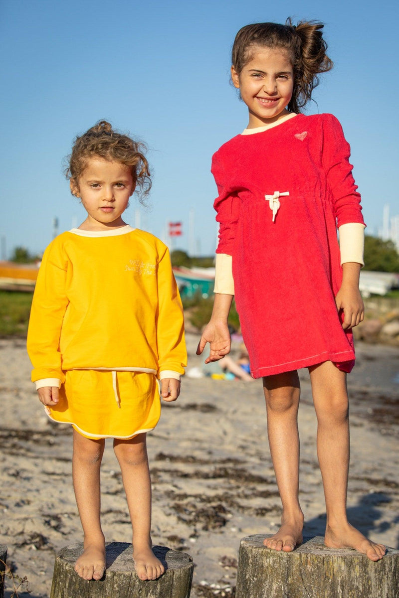 Load image into Gallery viewer, Two girls wearing organic cotton sets in bright colours
