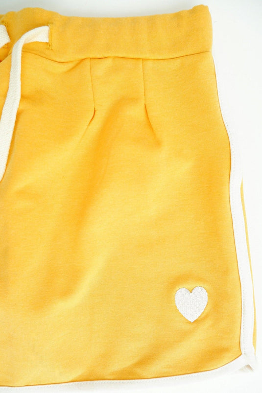 Logo detail of yellow jersey skirt in organic cotton for girls 