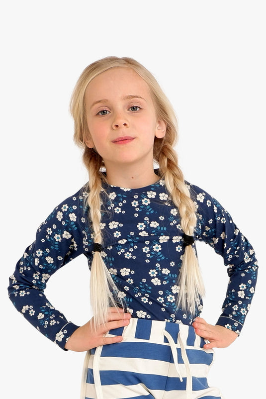 Scandinavian child wearing dark blue blouse in organic cotton