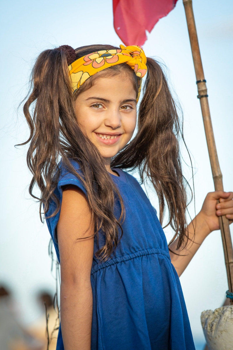 Load image into Gallery viewer, Scandinavian girl wearing our Blue organic dress in retro look and yellow bandana
