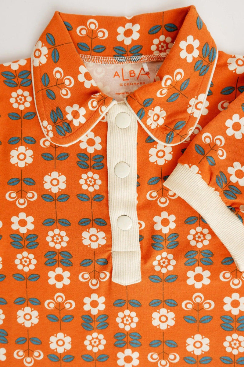 Load image into Gallery viewer, Front detail of Julie dress in organic orange cotton with small flowers
