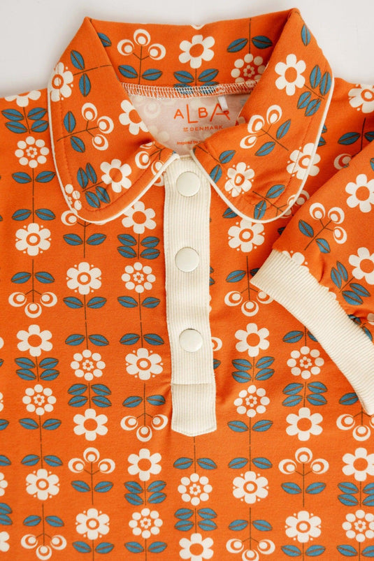 Front detail of Julie dress in organic orange cotton with small flowers