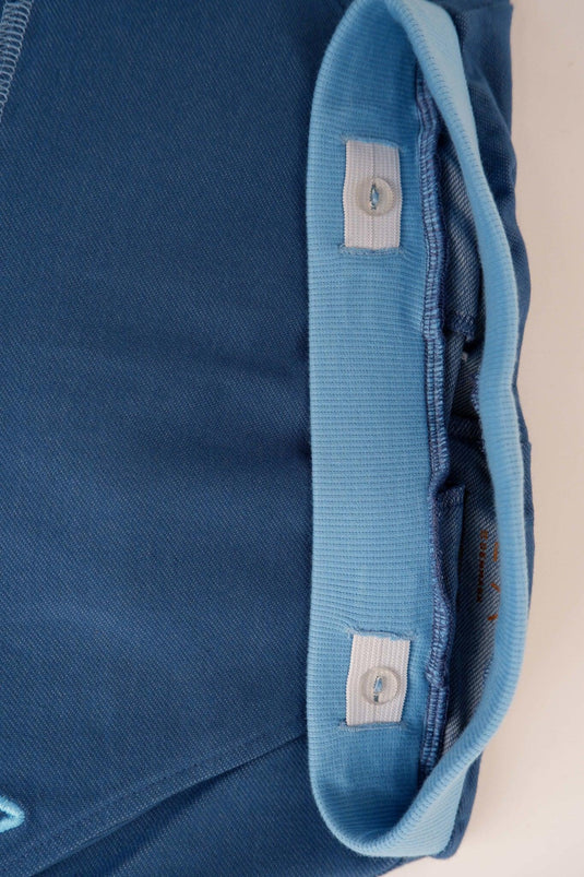 Waist detail of mason pants in organic blue cotton soft jersey for children