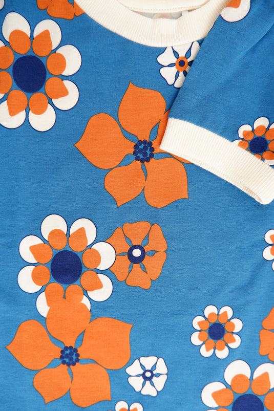 Detail of Retro blue blouse in organic cotton and big orange flowers