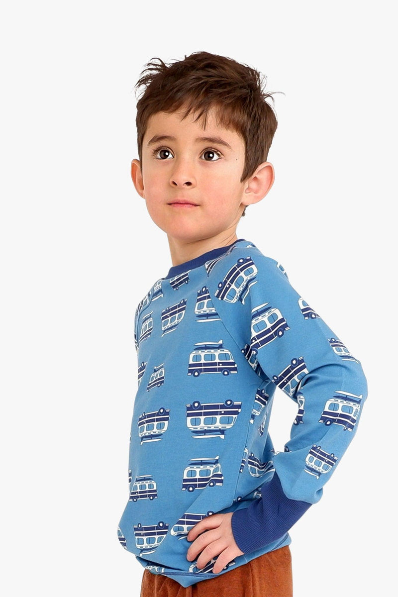 Load image into Gallery viewer, Danish child wearing blue organic t-shirt with long arms and boat print
