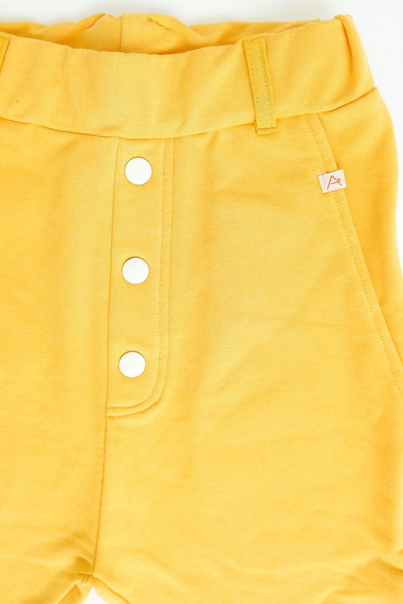 Load image into Gallery viewer, front of a pair of yellow shorts made with Organic Sweat fabric
