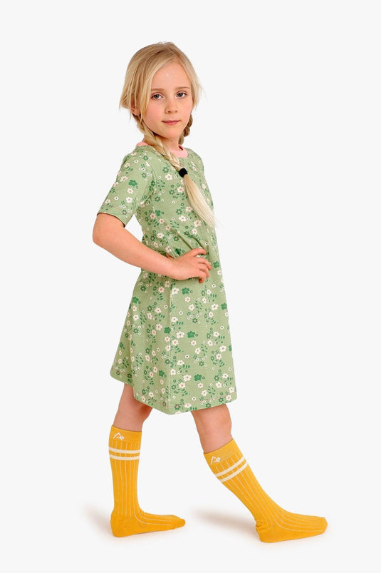 Blond girl wearing Girls summer dress in green and pink organic cotton and flowers