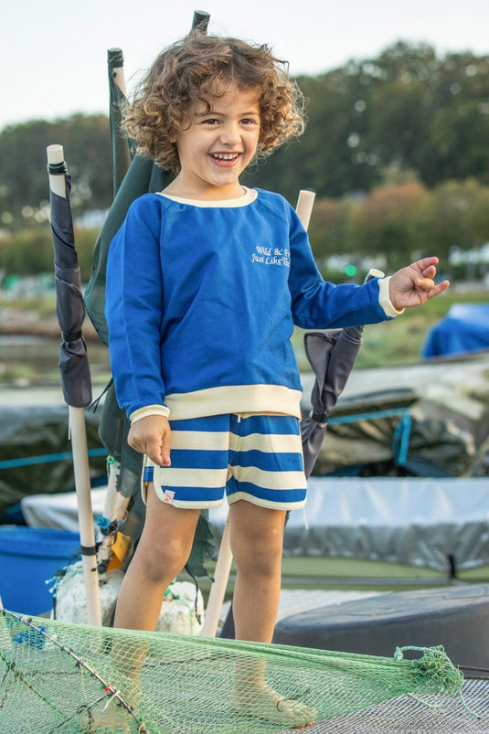 Small child wearing Race shorts in blue breton stripe for children